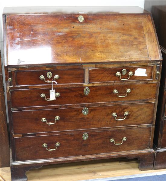 A Georgian mahogany bureau, fitted fall front and five drawers, on bracket feet, W 40.5in W.104cm